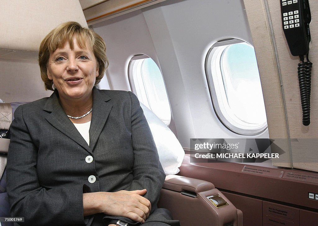 German chancellor Angela Merkel sits wit