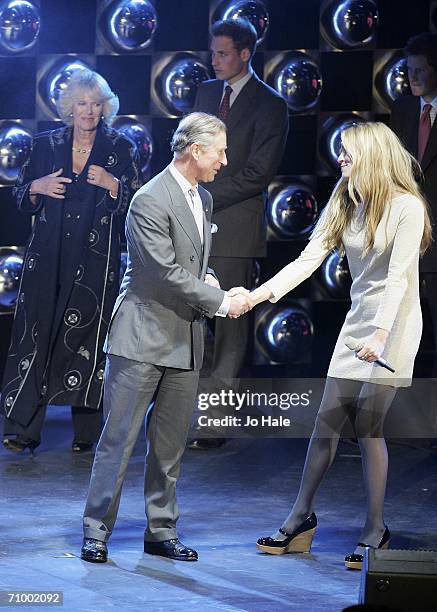 Host Cat Deeley shakes HRH Prince Charles, Prince of Wales's hand on stage as firewaorks go off at the finale of The Prince's Trust 30th Live concert...