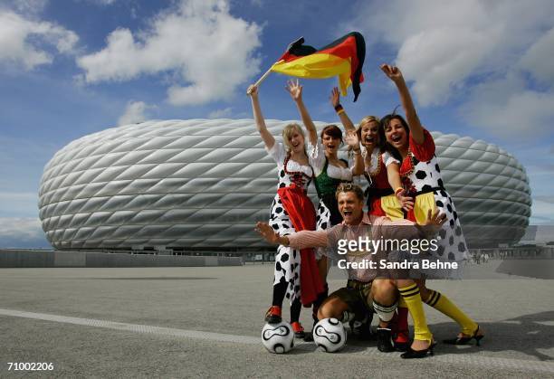 Models present traditional Bavarian clothes in a football style at the Allianz Arena on May 21, 2006 in Munich, Germany. The collection has been...