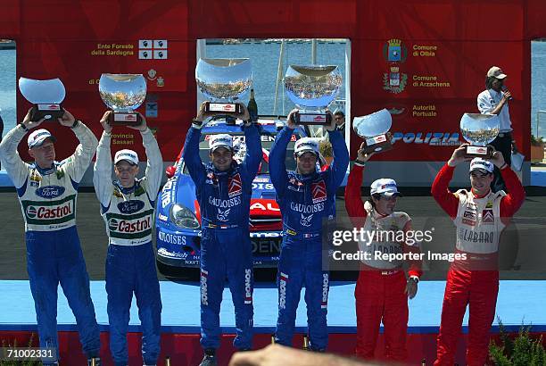 Sebastien Loeb, Daniel Elena, Mikko Hirvonen, Jarno Lehtinen, Daniel Sordo, and Marc Marti stand on the Podium during Leg 3 of the Rally of Italy...