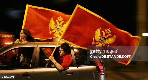 Podgorica, SERBIA AND MONTENEGRO: Supporters of Montenegrin independence wave a Montenegrin flag and celebrate in Podgorica, 21 May 2006, after an...