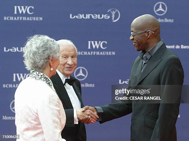 Former head of the International Olympic committee Juan Antonio Samaranch shakes hands with US ex-sprinter Edwin Moses on arrival at the annual...