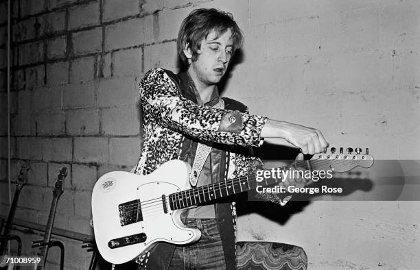 James Honeyman-Scott, lead guitarist with the British rock band The Pretenders, tunes his guitar before their first American concert tour stop in...