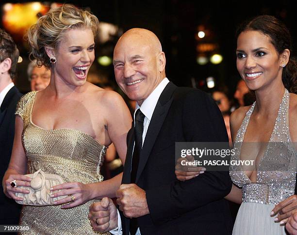 British actor Patrick Stewart poses with US actresses Rebecca Romijn and Halle Berry upon arriving at the Festival Palace to attend the premiere of...