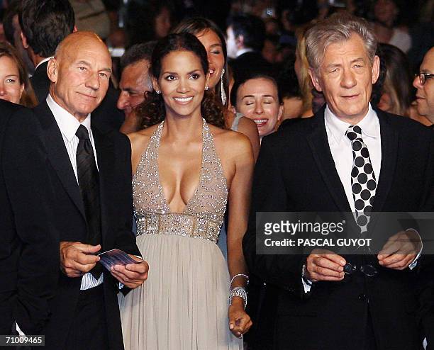 British actors Patrick Stewart and Ian McKellen pose with US actress Halle Berry upon arriving at the Festival Palace to attend the premiere of US...