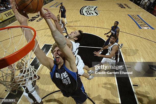 Dirk Nowitzki of the Dallas Mavericks goes to the basket against Manu Ginobili of the San Antonio Spurs in game seven of the Western Conference...