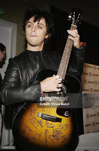 Musician Billie Joe Armstrong of the band Green Day holds an autographed Epiphone acoustic guitar at the 23rd Annual ASCAP Pop Music Awards on May...