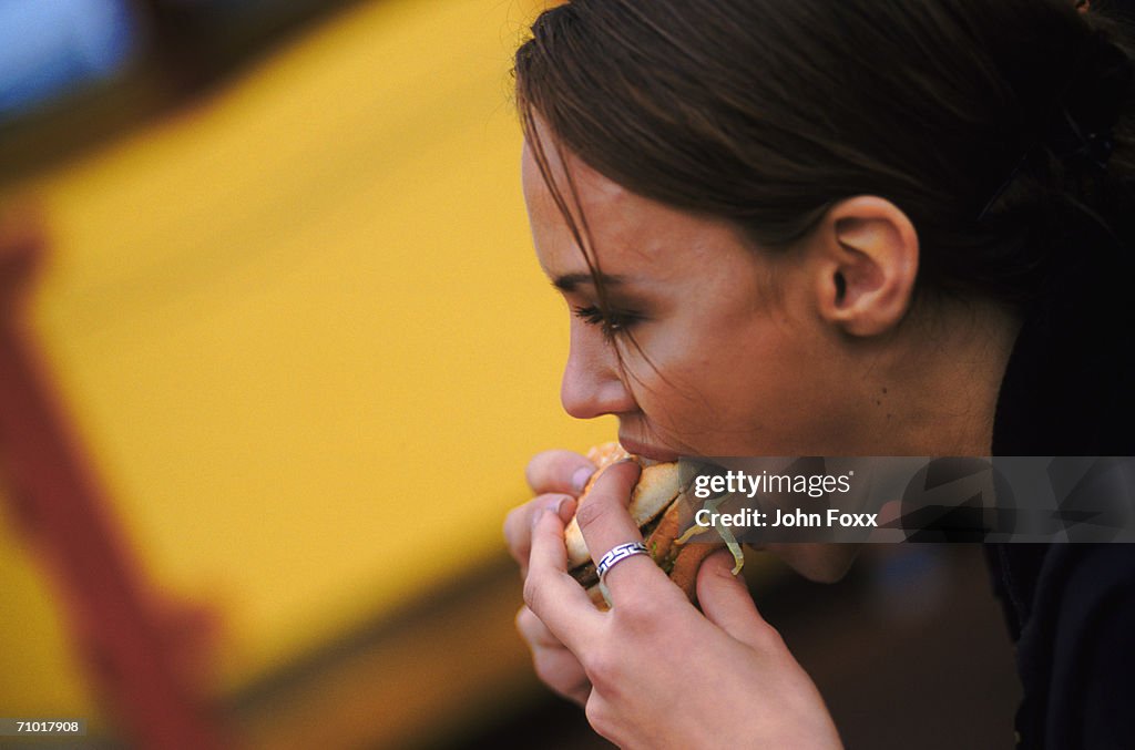 Woman eating hamburger and French fries