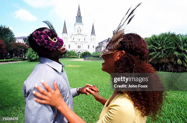 young couple wearing eye masks and dancing, smiling - jackson square new orleans stock pictures, royalty-free photos & images