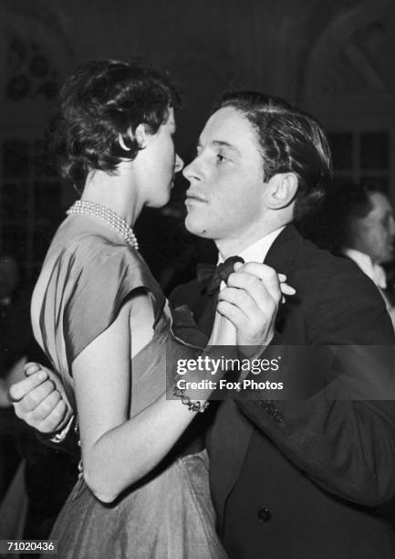 William Herbert Smith, 4th Viscount Hambleden, dancing at a charity ball at the Savoy Hotel, London, 1952. Smith is the nephew of the Hon. David...