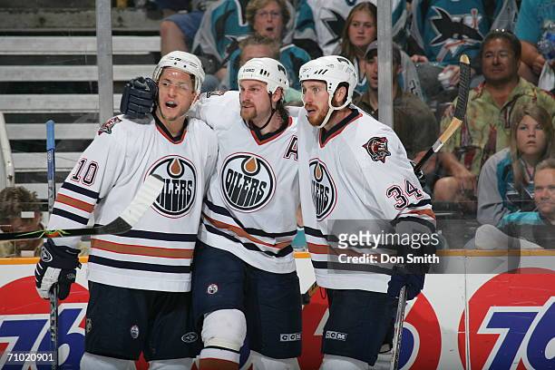 Shawn Horcoff, Ethan Moreau adn Fernando Pisani of the Edmonton Oilers celebrate a third period goal during game five of the Western Conference...