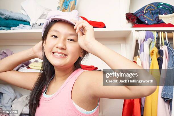 portrait of a girl holding a cap - closet one girl only stock pictures, royalty-free photos & images