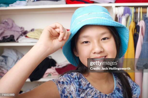 portrait of a girl holding a hat - closet one girl only stock pictures, royalty-free photos & images