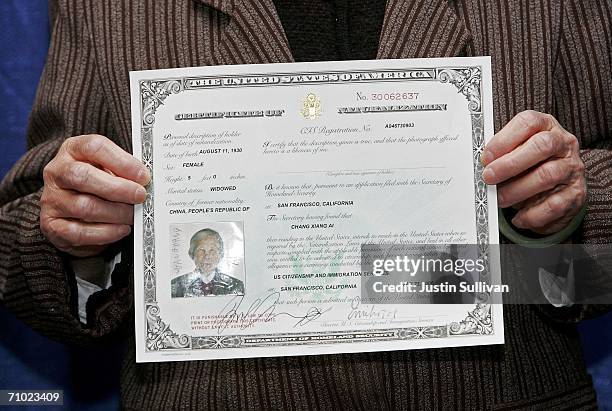 Newly naturalized U.S. Citizen Chang Xiang of China holds her certificate of naturalization after being sworn in as a U.S. Citizen during a...