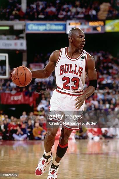 Michael Jordan of the Chicago Bulls dribbles during a game played circa 1992 at Chicago Stadium in Chicago, Illinois. NOTE TO USER: User expressly...