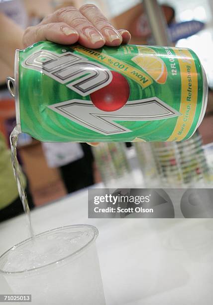 Cadbury Schweppes representative pours a sample of reformulated "100% Natural" 7-Up soda at the National Restaurant Association's annual trade show...