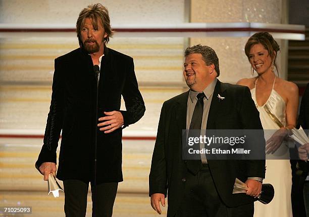 Ronnie Dunn of the band Brooks & Dunn and producer Craig Wiseman accepts the award for Song of the Year from television personality Hannah Storm...