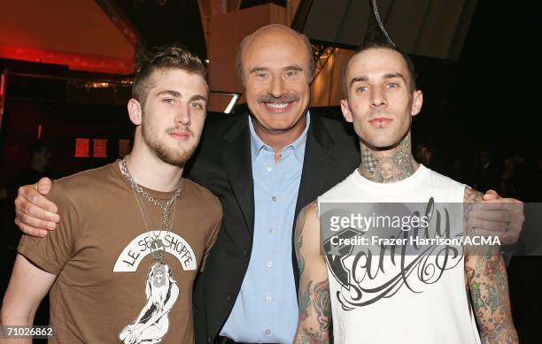 Drummer Travis Barker poses with TV personality Dr. Phil McGraw, and his son Jordan McGraw backstage during the 41st Annual Academy Of Country Music...