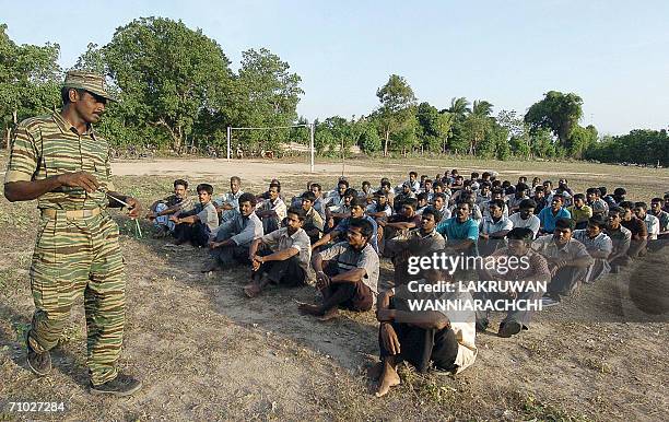 Sri Lankan Tamil Tiger guerrilla gives instuctions to villagers ahead of a "self-defence training" in the Liberation Tigers of Tamil Eelam...