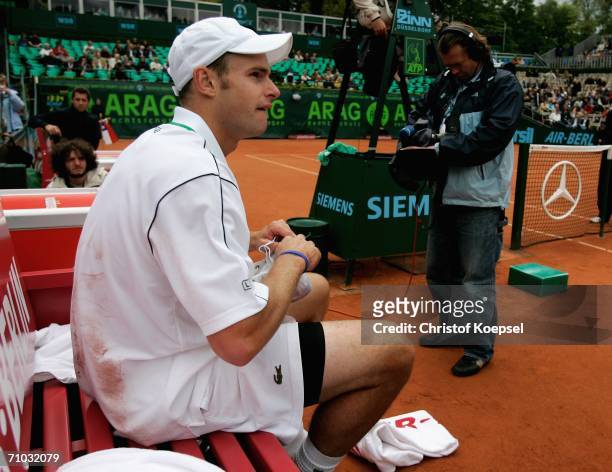 Andy Roddick of the USA sits on the bench with an injury during the match against Nicolas Massu of Chile during Day 4 of the ARAG World Team Cup at...