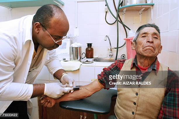 Cuban oftalmologist Fernando Robles takes a blood sample of Aymara peasant Pablo Barrios from neighboring Yunguyo, Peru 09 May, 2006 at a...