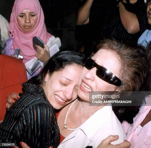 Egyptian Hind Hennawi cries as she hugs her mother after she won the parental suit against actor Ahmad al-Fishawi, 24 May 2006 in Cairo. The judge...