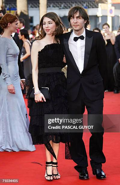 Director Sofia Coppola poses with her companion Phoenix singer Thomas Mars upon arriving at the Festival Palace to attend the premiere of her film...