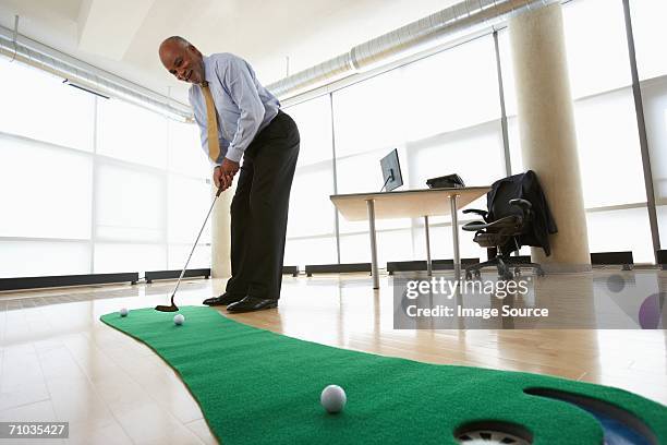 ceo practicing putting - indoor golf stock pictures, royalty-free photos & images