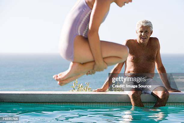 young girl diving into swimming pool - old people diving stock pictures, royalty-free photos & images
