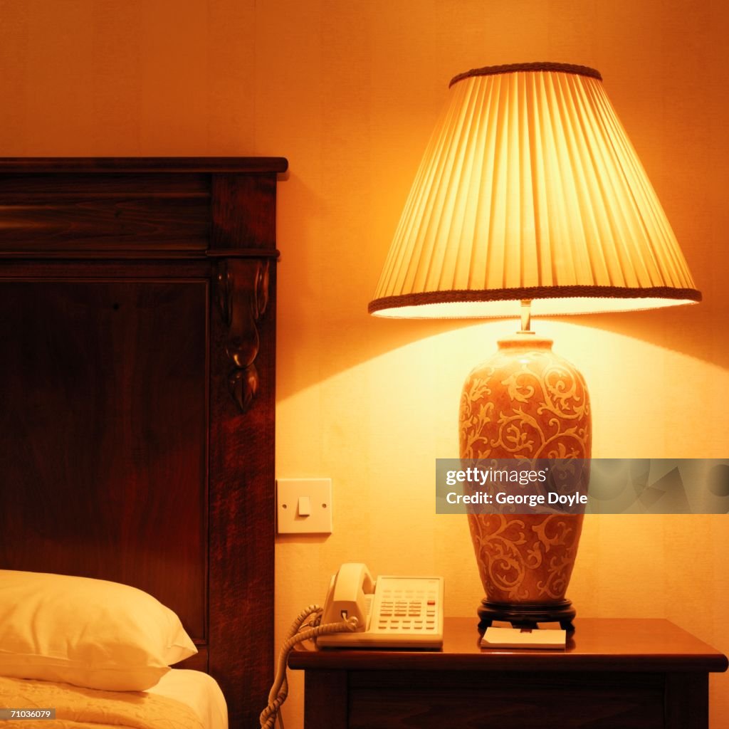 Close-up of a lamp on a nightstand