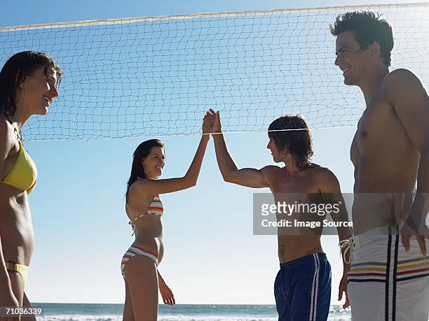 couple playing volleyball - champions day four stock pictures, royalty-free photos & images