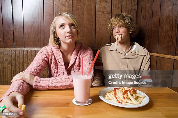 teenage couple in a cafe - teenage romance stock pictures, royalty-free photos & images