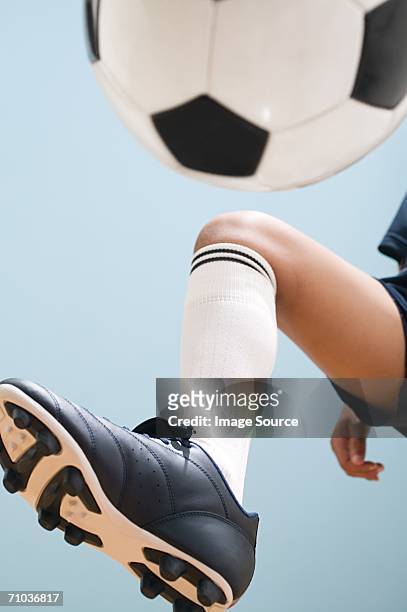boy playing keepy uppy - soccer boot stock pictures, royalty-free photos & images