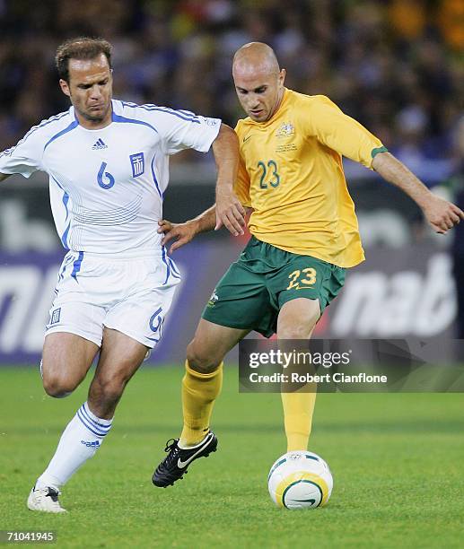 Angelos Basinas of Greece challenges Marco Bresciano of Australia during the Powerade Cup international friendly match between Australia and Greece...