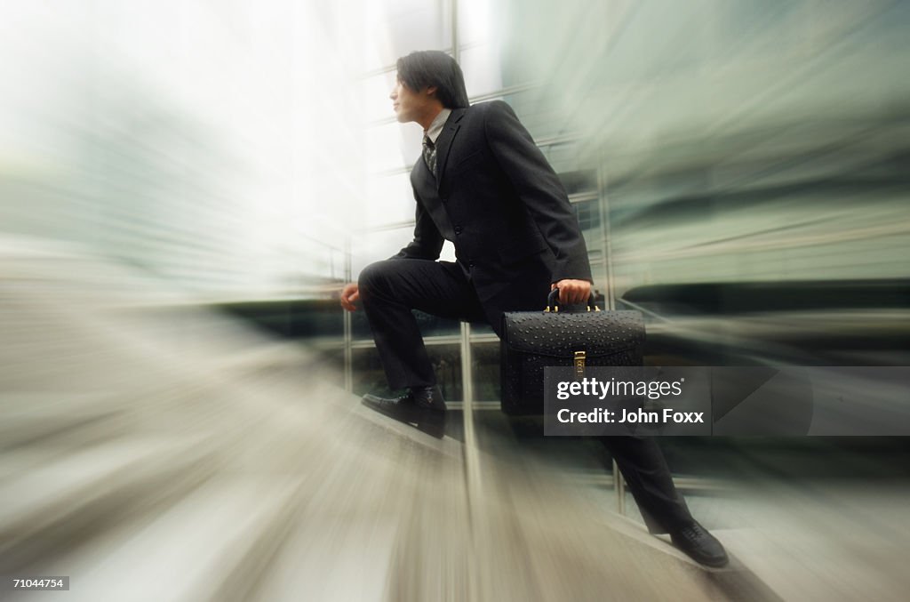 Businessman walking on steps (blurred motion)