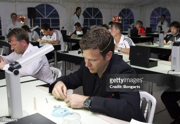 Oliver Bierhoff works on a watch during a visit of the German national football team to a watchmakers on May 24, 2006 in Geneva, Switzerland
