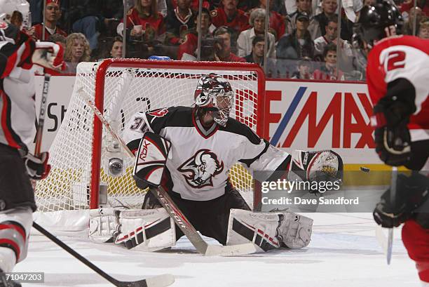 Goaltender Ryan Miller of the Buffalo Sabres reaches for the puck on a shot by the Ottawa Senators in game five of the Eastern Conference Semi-finals...