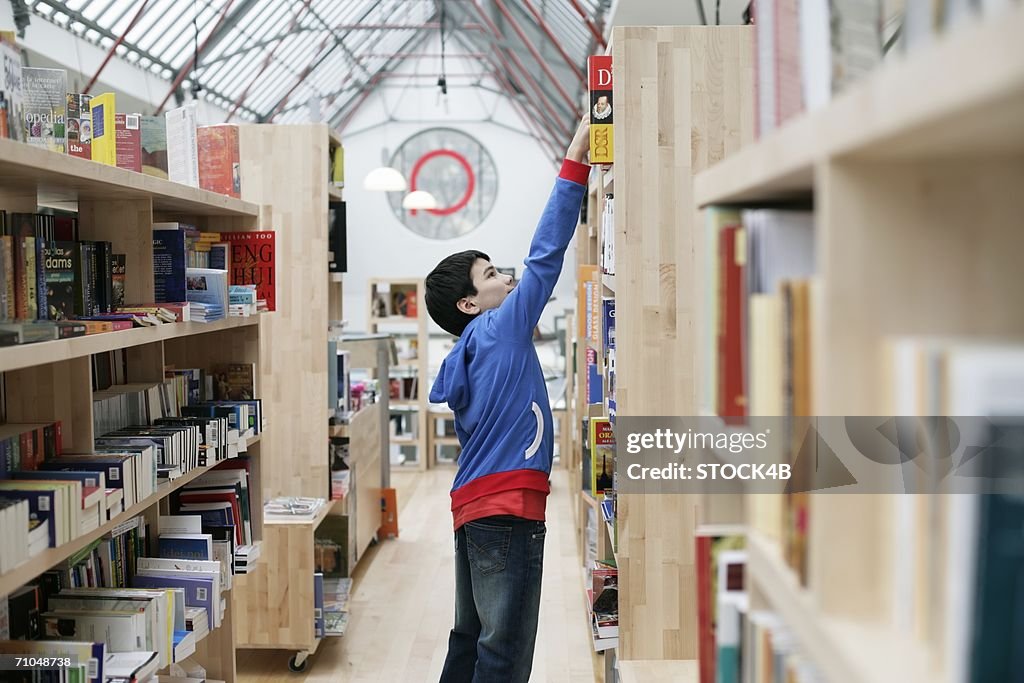 Boy selecting a book from a shelf