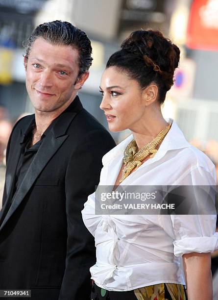 Member of the Jury Italian actress Monica Bellucci and her companion French actor Vincent Cassell pose upon arriving at the Festival Palace to attend...