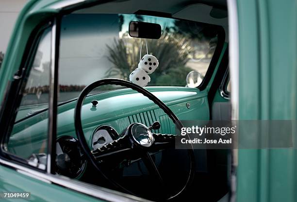 classic car with fuzzy dice hanging from the rear-view mirror. - gear shift classic car photos et images de collection