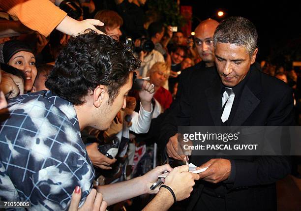 French actor Samy Naceri signs autographs upon leaving the Festival Palace following the premiere of French director Rachid Bouchareb's film...