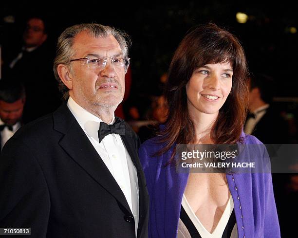 French journalist Serge July and a guest leave the Festival Palace following the premiere of French director Rachid Bouchareb's film 'Indigenes' at...