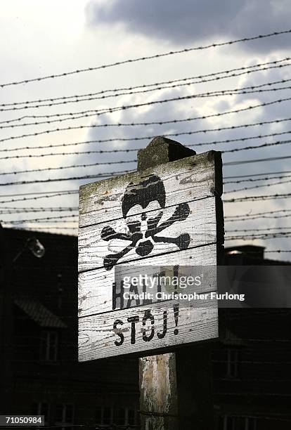Halt sign warning of an electric fence surrounding the Auschwitz concentration camp on May 25, 2006 Auschwitz, Poland. Polish citizens welcomed the...