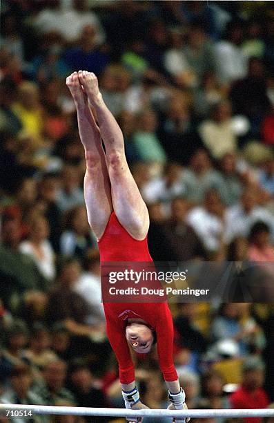 Elise Ray is doing her routine in the Uneven Bars Event during the U.S. Women's Olympic Gymnastics Trials at the Fleet Center in Boston,...