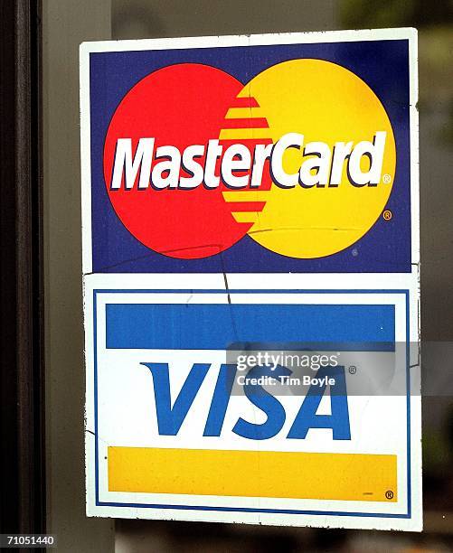 MasterCard sticker, above a Visa card sticker, is seen on a glass window of a store May 25, 2006 at its store in Niles, Illinois. MasterCard shares...