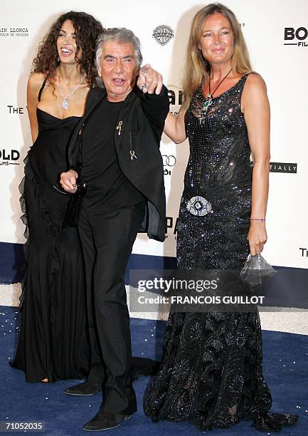 Italian designer Roberto Cavalli gestures as he arrive with guests to attend the amfAR?s annual "Cinema Against AIDS 2006" event at Le Moulin de...