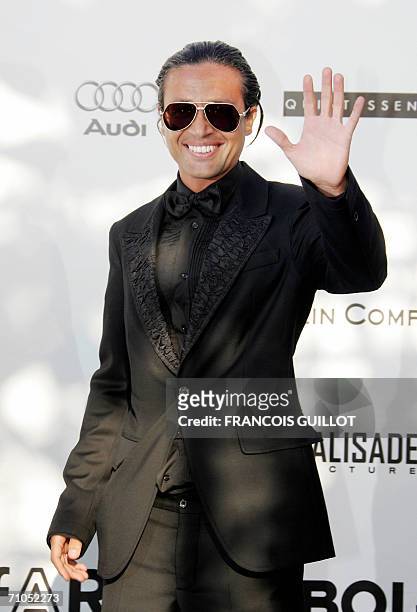 Lebanese businessman Omar Harfouch waves upon arriving to attend the amfAR?s annual "Cinema Against AIDS 2006" event at Le Moulin de Mougins during...