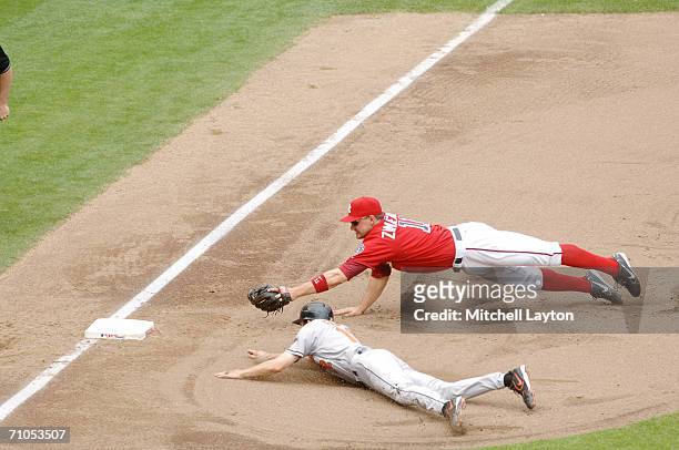 Ryan Zimmerman of the Washington Nationals dives to tag Brandon Fahey of the Baltimore Orioles in baseball game on May 21, 2006 at RFK Stadium in...