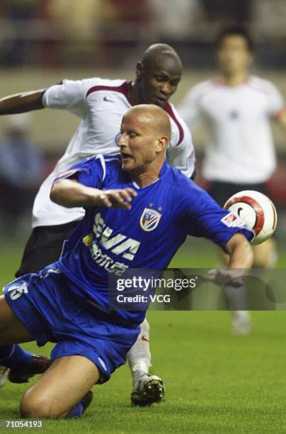 Former German International Carsten Jancker challenges for the ball during the match between Shanghai Shenhua and Liaoning at Hongkou Stadium on May...