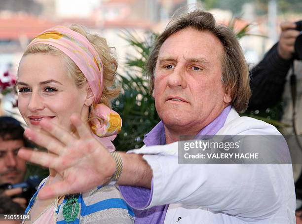 French actor Gerard Depardieu gestures as he poses with Belgian actress Cecile de France during a photocall for French director Xavier Giannoli's...